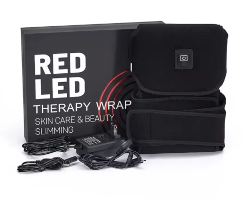 LUMAKIN therapy wrap folded next to its box and power adapter